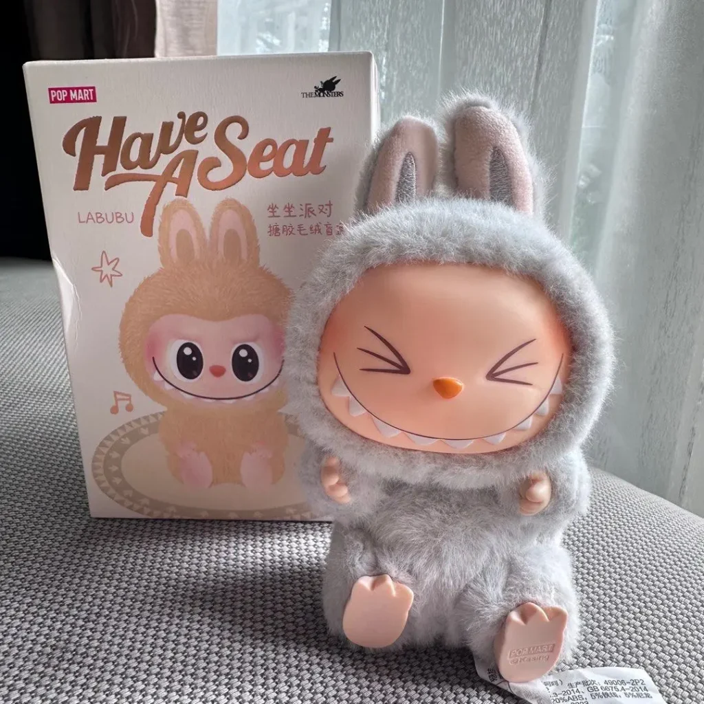 Have a Seat Hehe displayed with sit-pose Dada/Sisi on a floating shelf