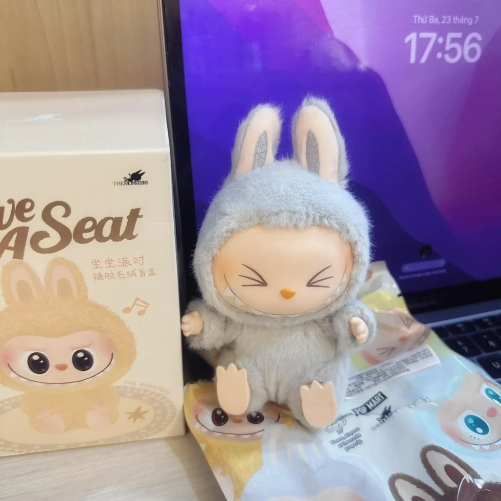 Hehe Labubu cover photo — smiling sit-pose figure on a clean white shelf