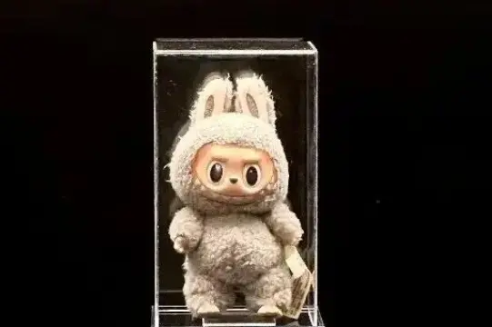 Toffee Labubu displayed in an acrylic case under neutral lighting